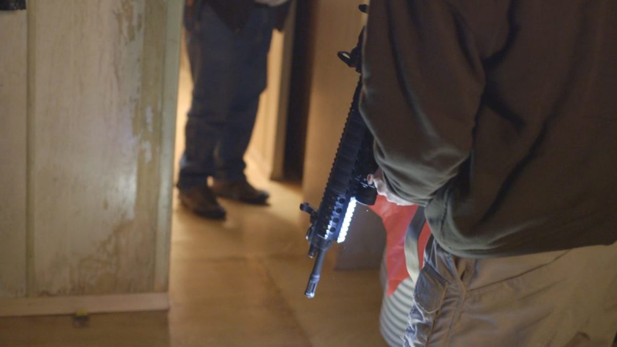 Armed occupiers explore and secure buildings at the Malheur National Wildlife Refuge headquarters. Film still from NO MAN'S LAND.
