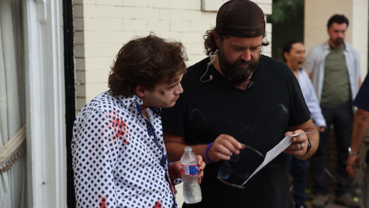 [L-R] Emile Hirsch and co-writer/director Brian Skiba behind the scenes of the thriller film, PURSUIT, a Lionsgate release. Photo courtesy of Lionsgate.