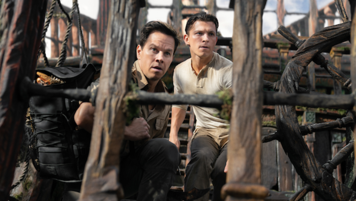[L-R] Victor "Sully" Sullivan (Mark Wahlberg) and Nathan Drake (Tom Holland) look to make their move in Columbia Pictures' UNCHARTED. Photo by Clay Enos.