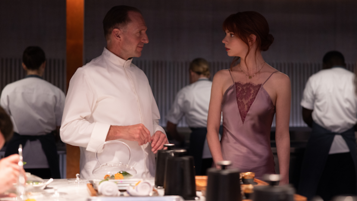 [L-R] Ralph Fiennes as Chef Slowik and Anya Taylor-Joy as Margot in the film THE MENU. Photo by Eric Zachanowich. Courtesy of Searchlight Pictures.
